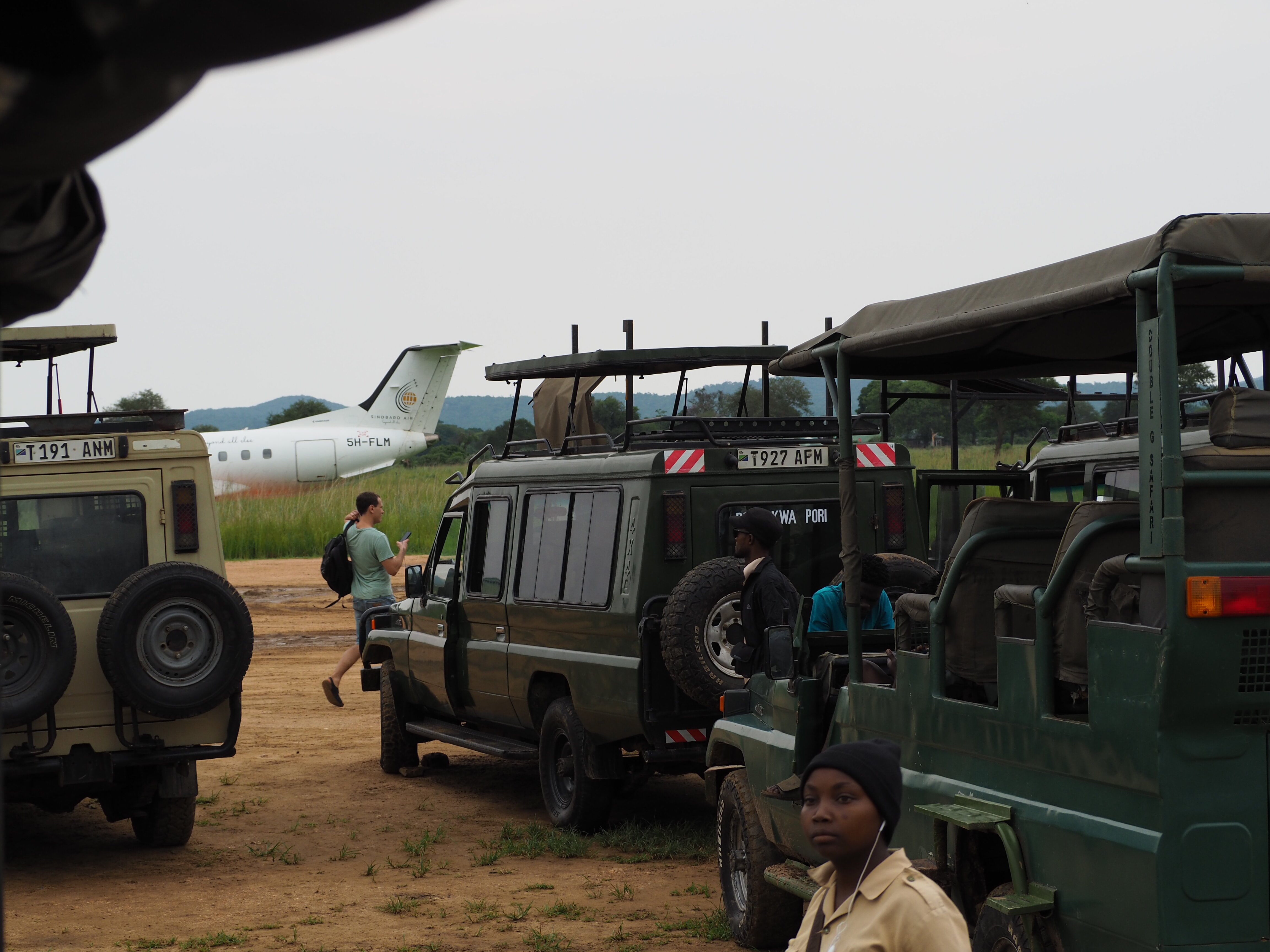 Safari vehicles and light aircraft at the airstrip